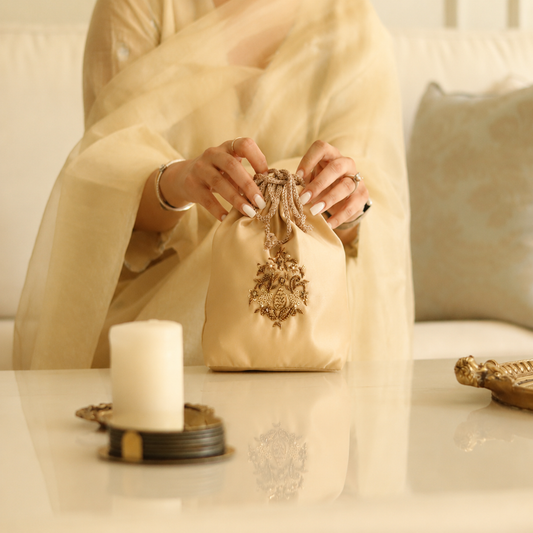 Inayaa – Champagne Gold Hand-Embroidered Zardozi Potli Bag